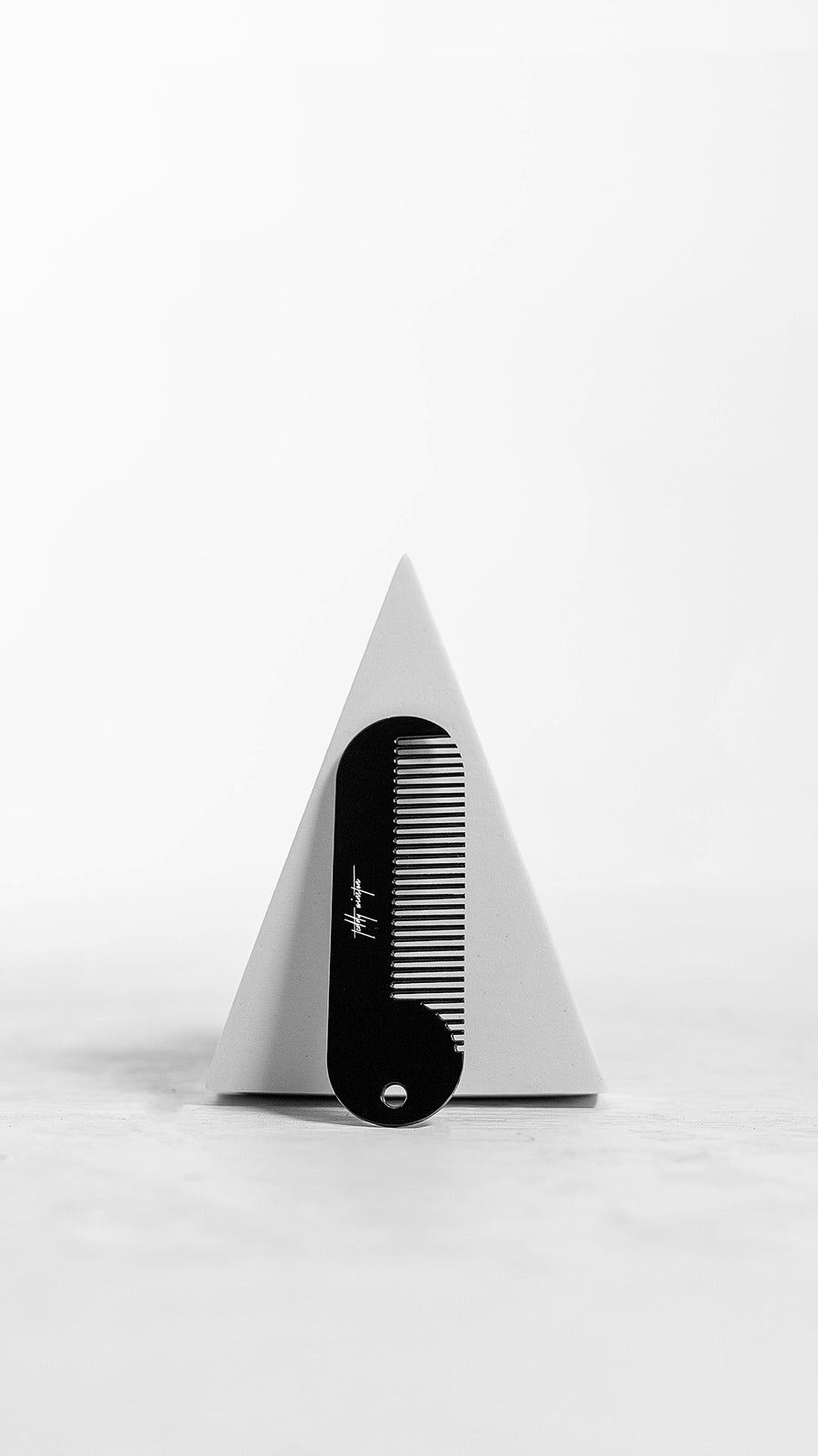 Powder coated hair comb that detangles, is virtually indestructible, and fits perfectly in the palm of your hand.